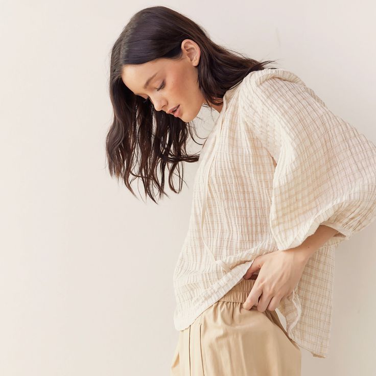 This textured cotton linen blend peasant blouse is a versatile addition to your wardrobe. Crafted from a blend of cotton, linen and span, this blouse offers a lightweight and breathable feel with a subtle texture that adds depth to the fabric. Designed with a classic peasant blouse silhouette with billowy sleeves and a relaxed fit. 82% Cotton, 15% Linen, 3% Span Amente, a Los Angeles based fashion house, strives for timeless and minimal sustainable fashion. The carefully select premium quality fabrics to create a collection of effortless pieces for the modern woman's wardrobe. They have been continuously focusing on looking at responsible and sustainable ways to conduct themselves in fashion. Fall Cotton Tops With Crinkle Texture, Chic Linen Peasant Top For Spring, Effortless Cotton Blouse For Fall, Daywear Long Sleeve Tops With Crinkle Texture, Long Sleeve Tops With Crinkle Texture For Daywear, Relaxed Fit Cotton Gauze Blouse, Casual Relaxed Fit Cotton Gauze Blouse, Spring Long Sleeve Cotton Gauze Tops, Spring Long Sleeve Ramie Tops