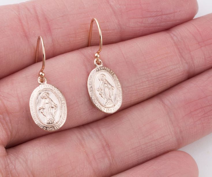 Dainty Oval Virgin Mary earrings in sterling silver, 14K gold filled and rose gold filled. Perfect for a Easter gift! Super dainty and wonderful for everyday wear! EARRING DESCRIPTION: - Oval Virgin Mary charm 14mm - sterling silver, gold filled and rose gold filled - Ear wires in sterling silver, gold filled and rose gold filled - Comes with plastic ear backs for a secure fit - Handmade and packaged beautifully for you! - - - - - - - - - - - - - - - - - - - - MATERIALS: - 14K Gold Filled: Gold Tarnish Resistant Sterling Silver Oval Earrings, Oval 14k Gold-filled Jewelry For Anniversary, 14k Gold-filled Oval Earrings, Nickel-free Rose Gold Earrings Gift, Hallmarked Oval Rose Gold Earrings, Rose Gold Nickel-free Earrings For Gift, Rose Gold 14k Gold-filled Earrings Gift, Rose Gold 14k Gold Earrings As Gift, Oval Rose Gold Hallmarked Earrings