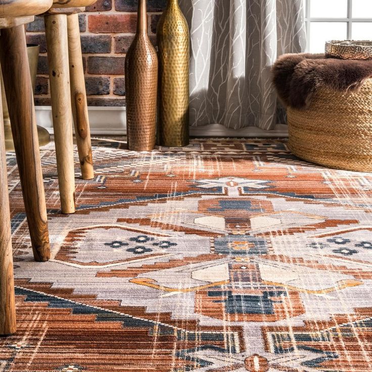 an area rug is shown in front of a brick wall and wooden chairs with vases on the floor