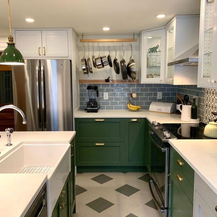 a kitchen with green cabinets and white counter tops