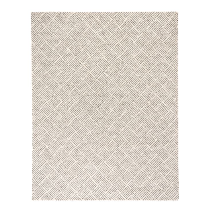 a white rug with an abstract pattern on it's side and the bottom half of the rug is made out of woven fabric