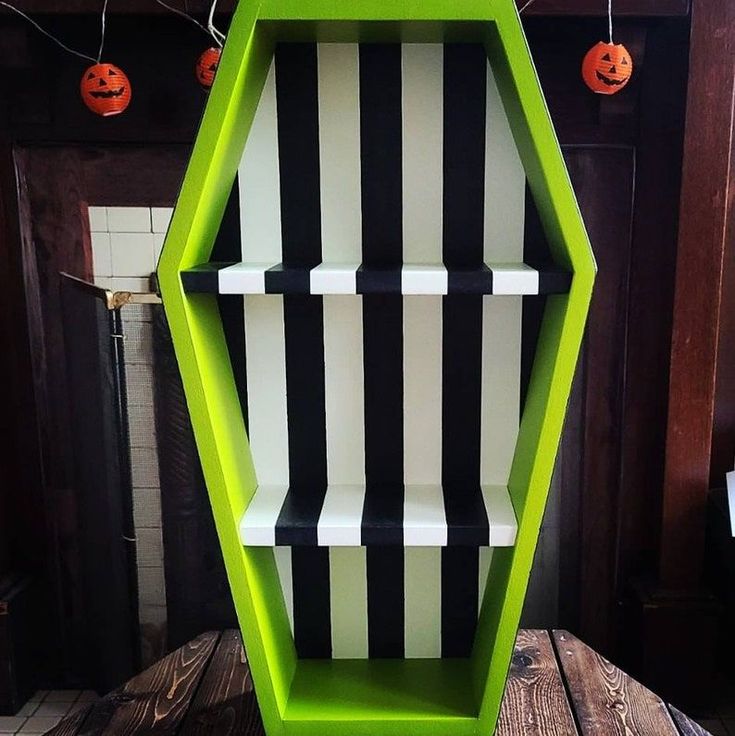 a green shelf with black and white stripes on it