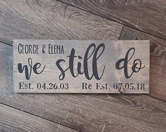 a wooden sign that says we still do on the side of a wood plank wall