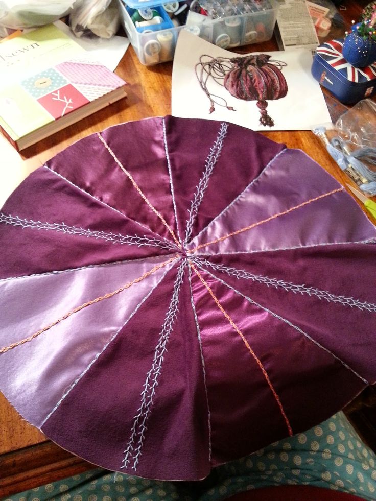 a purple umbrella sitting on top of a wooden table next to other crafting supplies