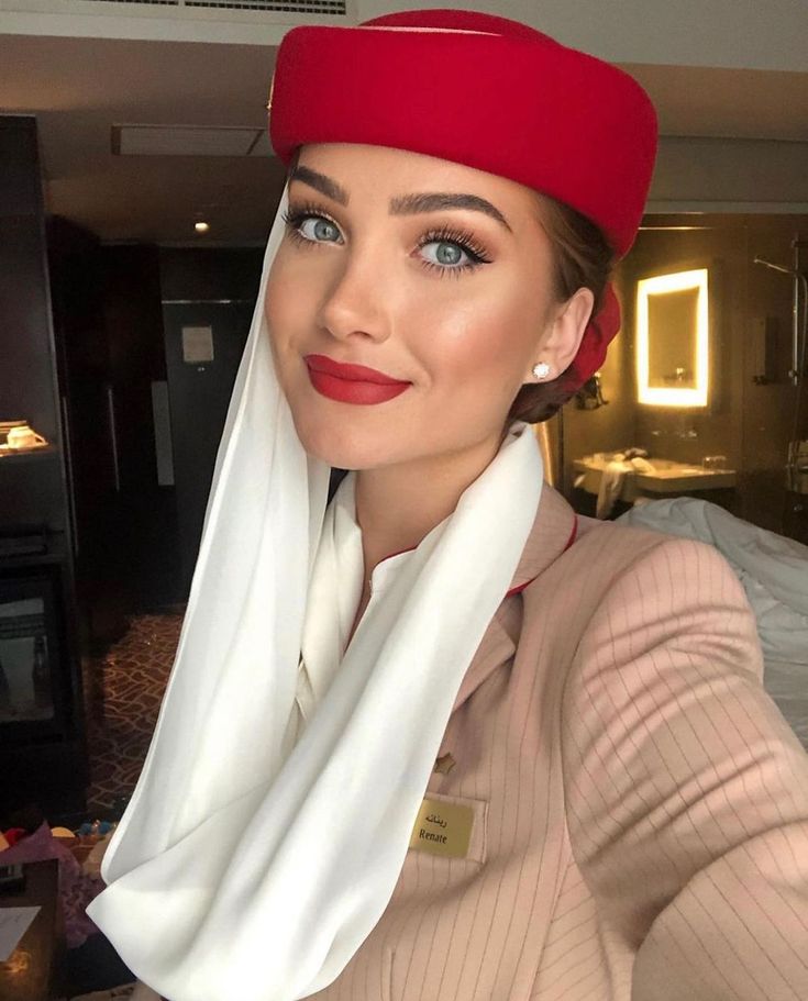 a woman wearing a red hat and white scarf