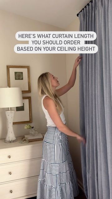 a woman standing in front of a curtain with the text here's what curtain length you should order based on your ceiling height