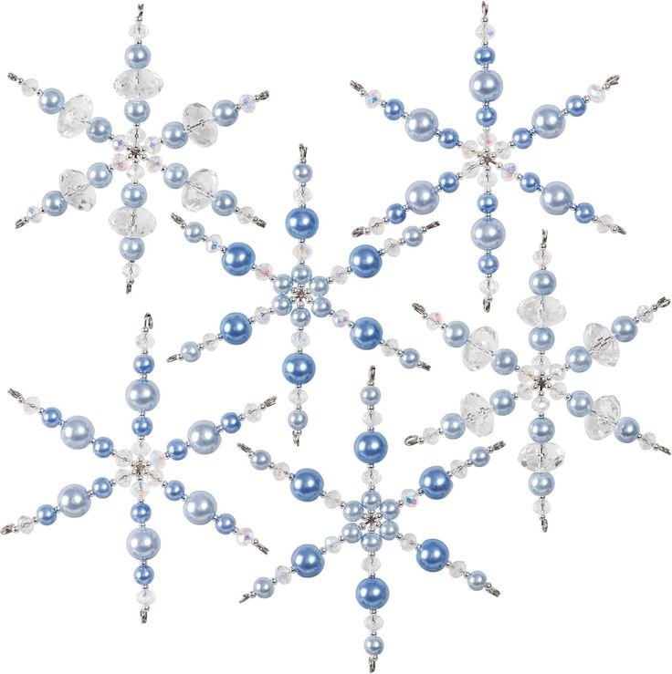 a snowflake made out of blue and white beads on a white background with clippings