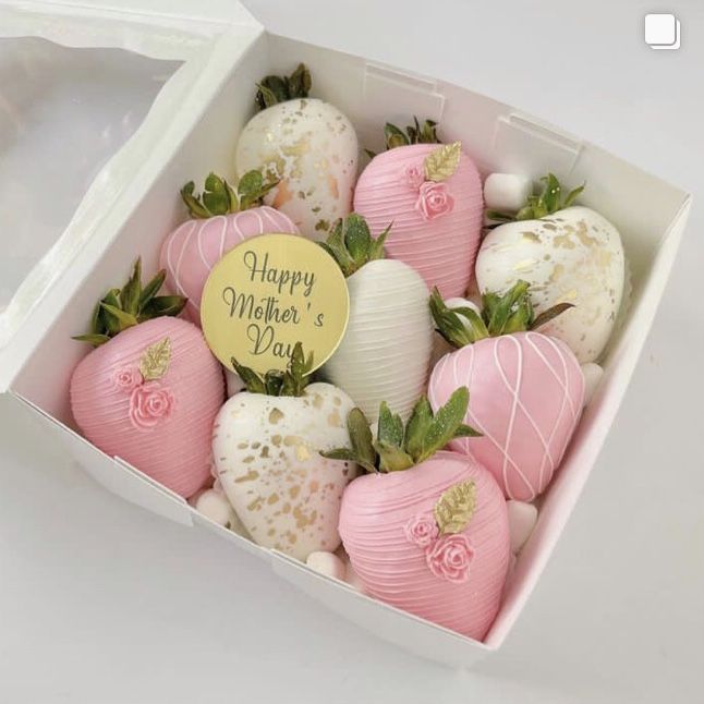 a box filled with pink and white strawberries next to a tag that says happy valentine's day