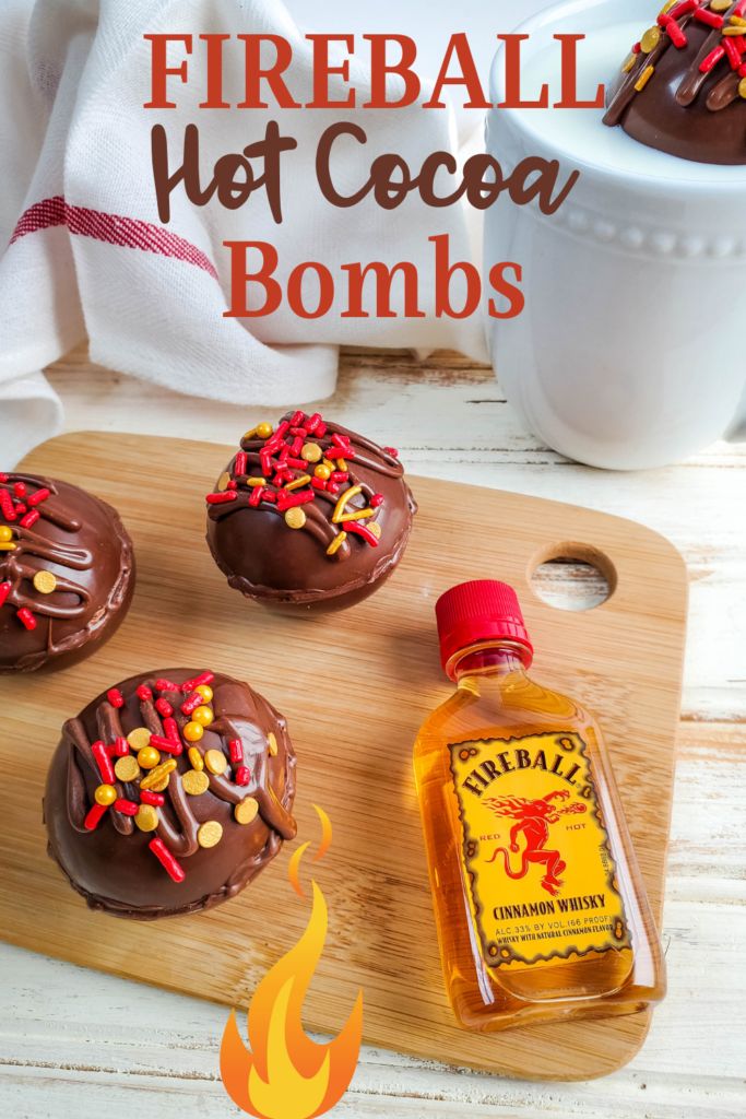 chocolate covered donuts with sprinkles and hot cocoa on top, sitting on a cutting board next to a bottle of booze