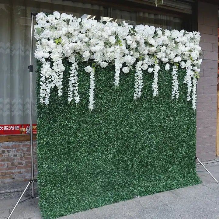 an artificial wall with white flowers on it