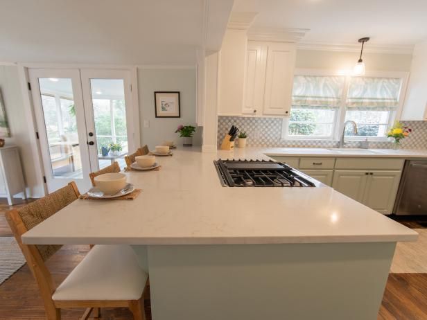 a kitchen with an island, stove and dining room table in the middle of it