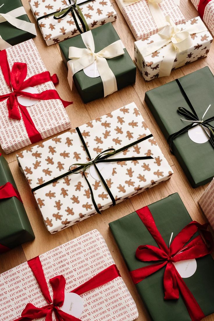 many wrapped presents sitting on top of a wooden table