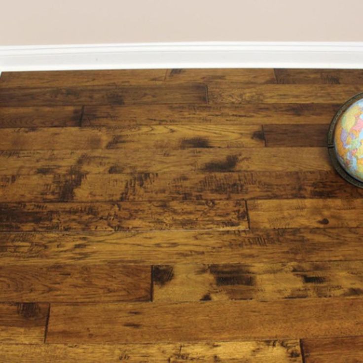 a wooden floor with a small globe on it