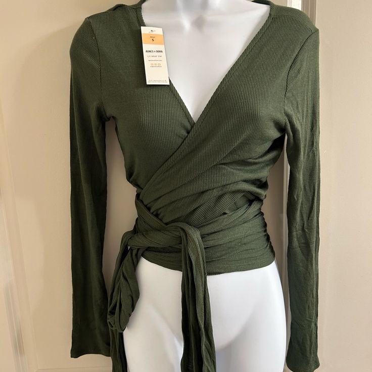 New Green Wrap Blouse. Has Very Long Wrap Around Sashes To Wear In Many Different Styles Chic Green Tops With Tie Waist, Fall Wrap Top For Brunch, Fall Season Wrap Top For Brunch, Fall Brunch Wrap Top, Wrap Top With Tie Waist For Brunch, Fall Season Tie Waist Wrap Blouse, Fall Wrap Blouse With Tie Waist, Fall Season Wrap Blouse With Tie Waist, Chic Green Wrap Top For Spring