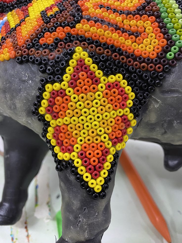 an elephant made out of beads is shown