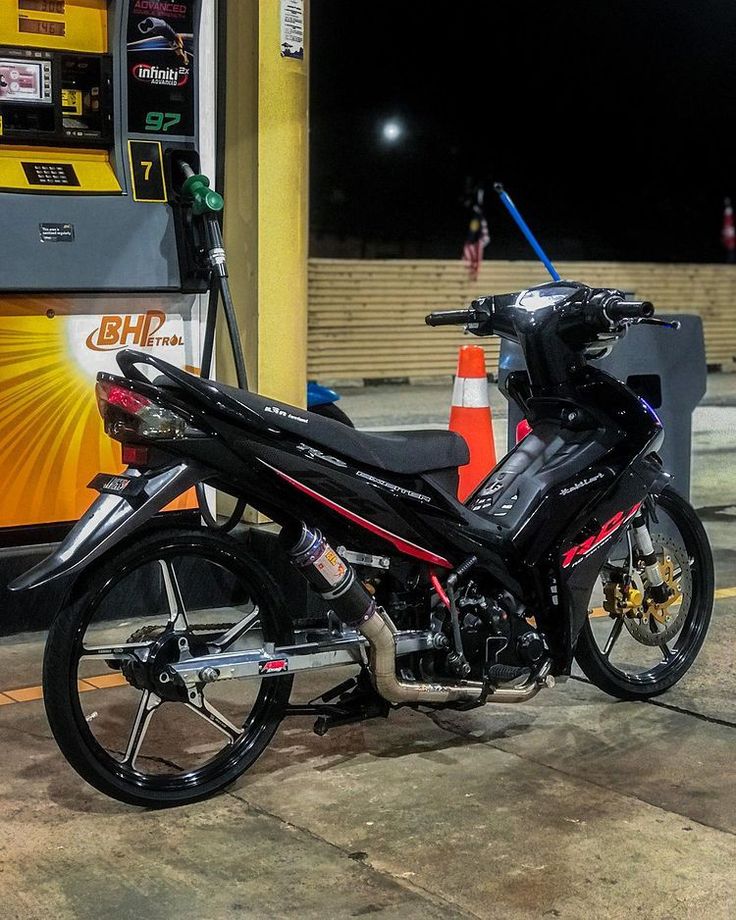 a motorcycle parked in front of a gas station