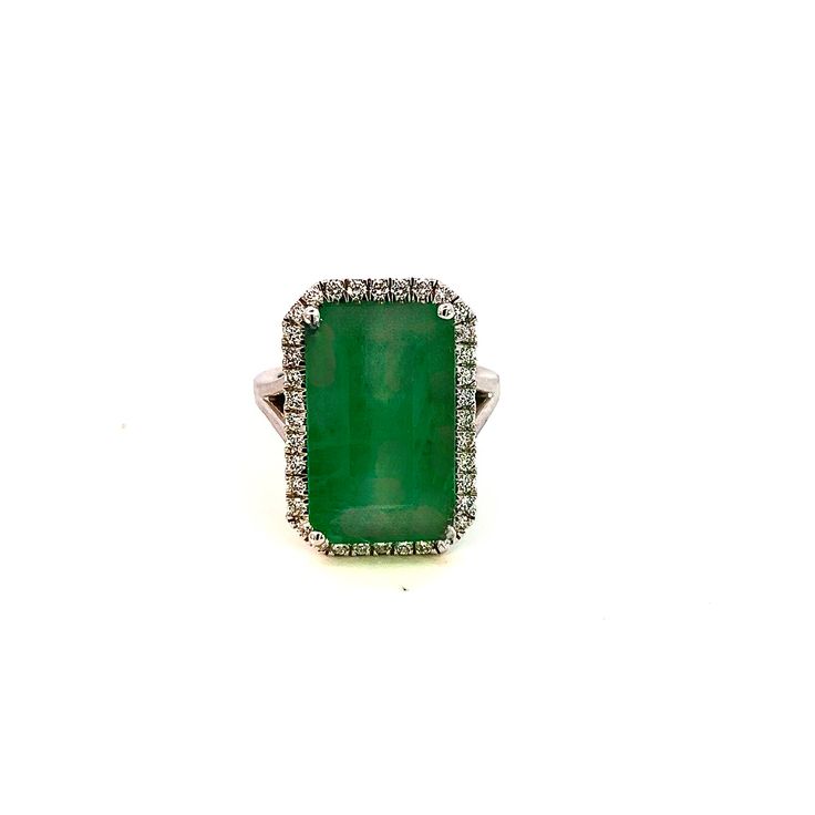 an emerald and diamond ring on a white background