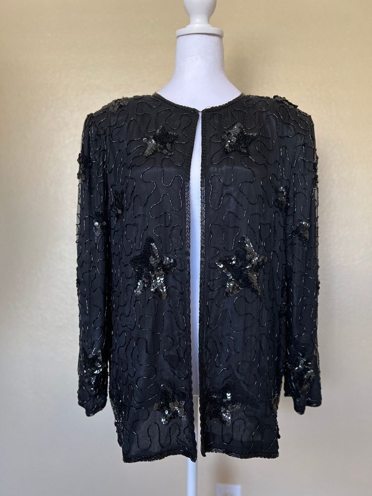 'American night' sequined jacket is made with 100% natural silk, 100% polyester lining, features Hook and eye collar button closure and shoulder pads. Size XL Measurements: shoulders: 17.5" Length: 27" Bust: 42" Sleeve length: 23" **a few beads are missing on the side back of the collar, it doesn't affect it's appearance.** Long Sleeve Sequined Blazer For Evening, Sequined Outerwear For Holiday Evenings, Embellished Long Sleeve Silk Outerwear, Silk Long Sleeve Outerwear For Evening, Winter Outerwear With Sequins, Winter Silk Blazer For Party, Winter Party Silk Blazer, Vintage Sequin Outerwear For Night Out, Silk Winter Party Outerwear