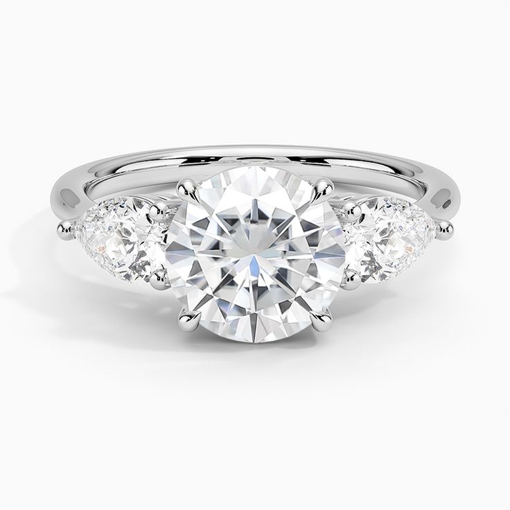 three stone engagement ring with diamonds on the side