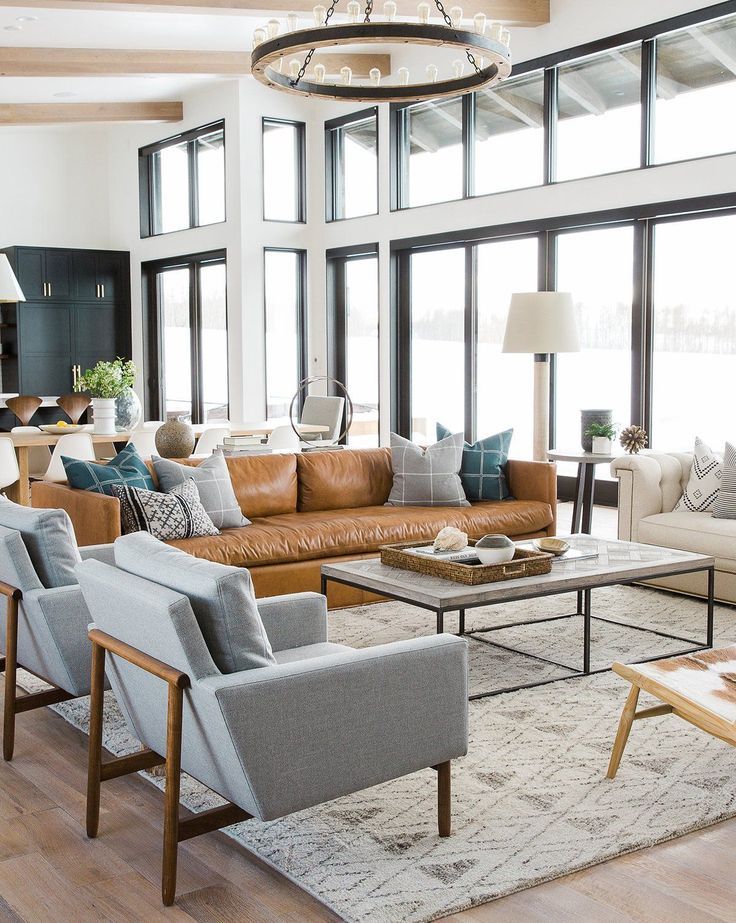 a living room filled with furniture and lots of windows