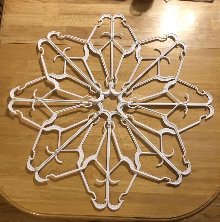 a wooden table topped with lots of white metal objects on top of it's surface