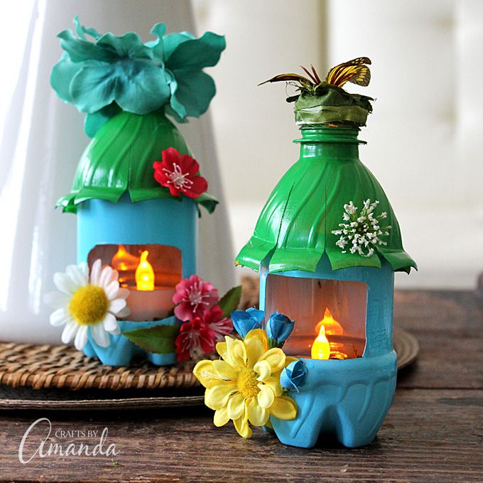 two small lanterns sitting on top of a wooden table