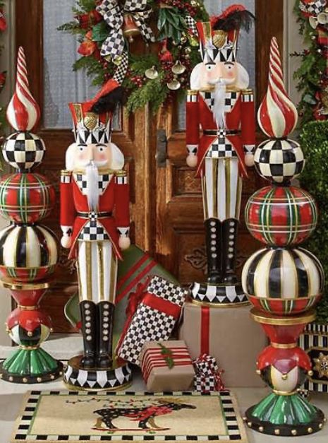 christmas decorations with nutcrackers and flags in front of a mirror on the floor