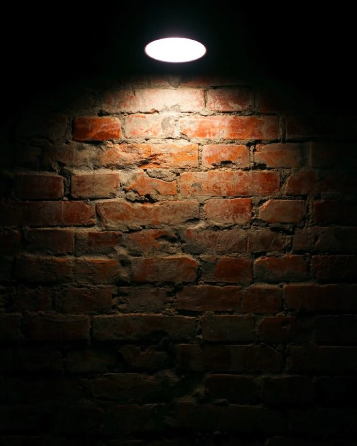 a brick wall with a light on it