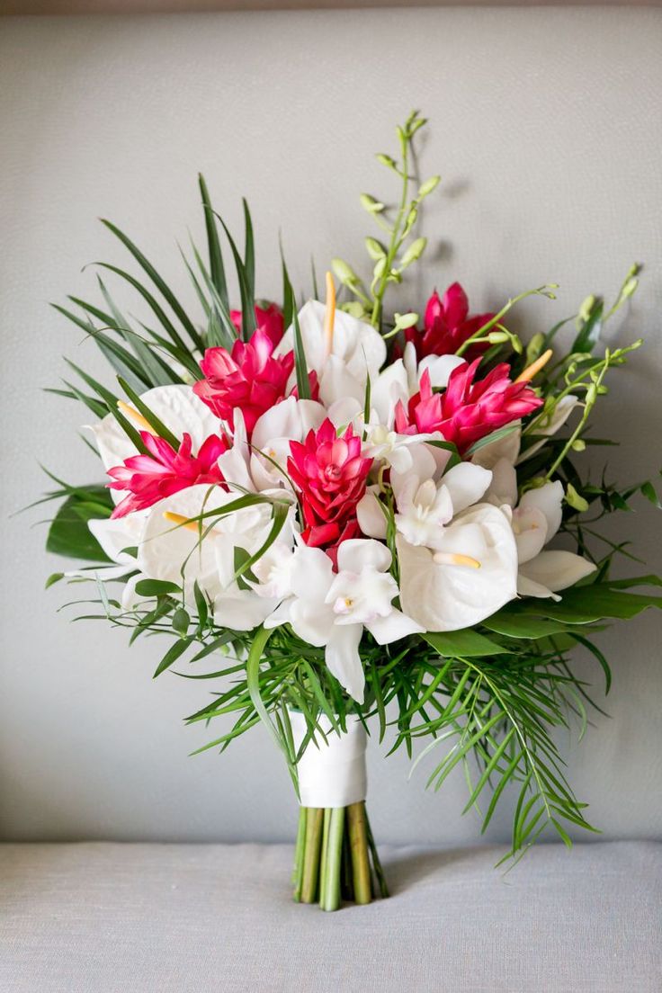 a bouquet of white and red flowers on a table