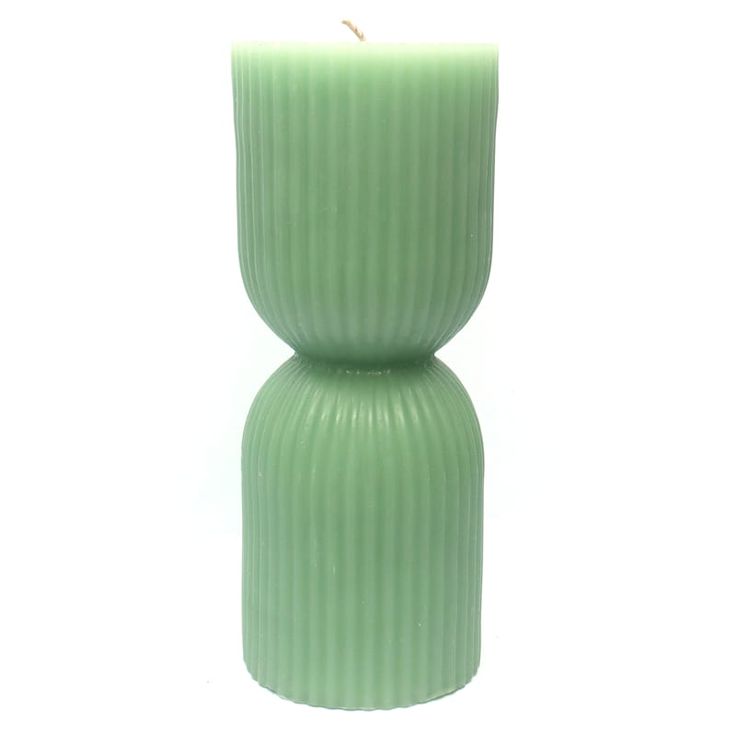 a green candle holder sitting on top of a white table