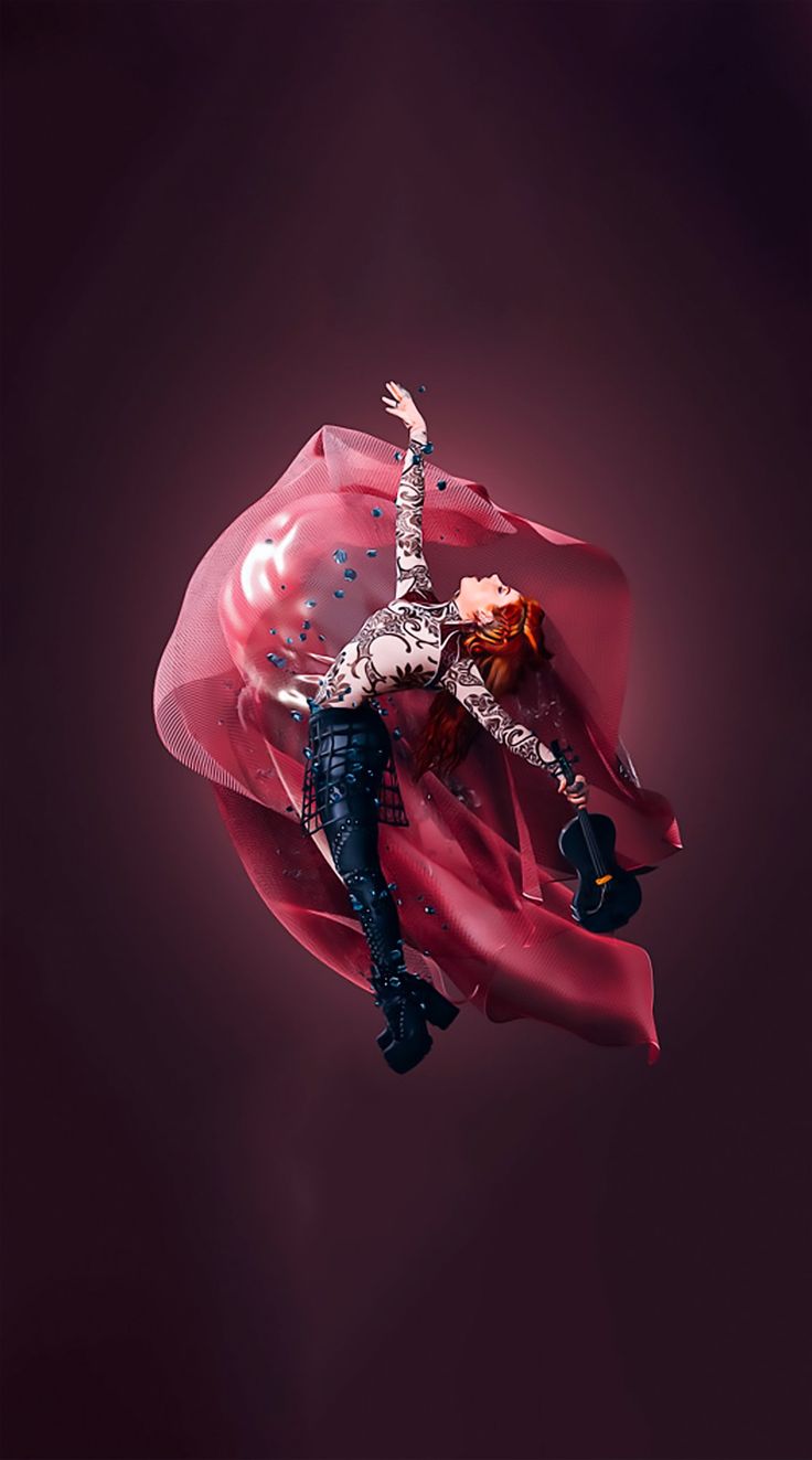 a woman is floating in the air with her arms outstretched