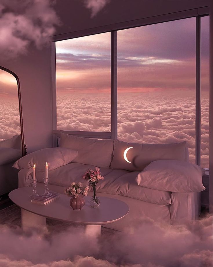 a couch sitting in the middle of a cloud filled room next to a large window