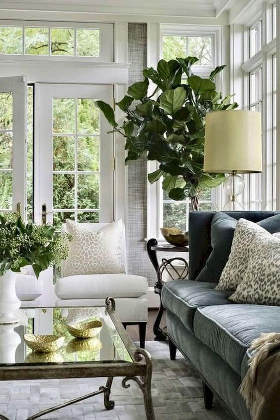 a living room with couches, chairs and a coffee table in front of windows