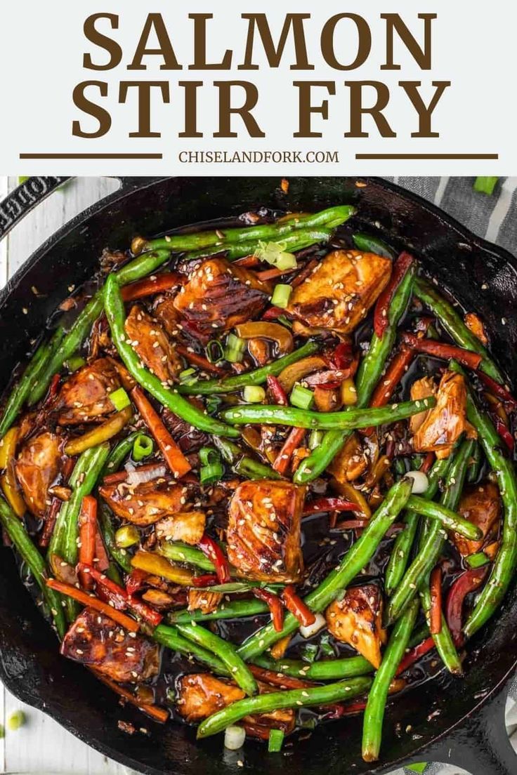 chicken stir fry in a skillet with green beans and carrots on the side