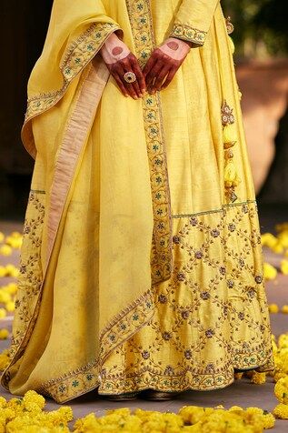 Yellow flared raw silk lehenga with buttercup bloom jaal zardozi embroidery on the border. Paired with a full sleeves raw silk padded blouse with floral zardozi embroidery on the sleeves, neckline and organza dupatta adorned with floral hand embroidered zardozi border. - Aza Fashions Slub Silk Wedding Sets With Dori Work, Slub Silk Sets With Dori Work For Wedding, Wedding Lehenga With Dori Work In Slub Silk, Wedding Slub Silk Choli With Cutdana, Wedding Choli With Zari Work In Slub Silk, Designer Slub Silk Lehenga With Gota Work, Wedding Traditional Wear With Dori Work In Slub Silk, Slub Silk Traditional Wear With Dori Work For Wedding, Wedding Slub Silk Traditional Wear With Dori Work