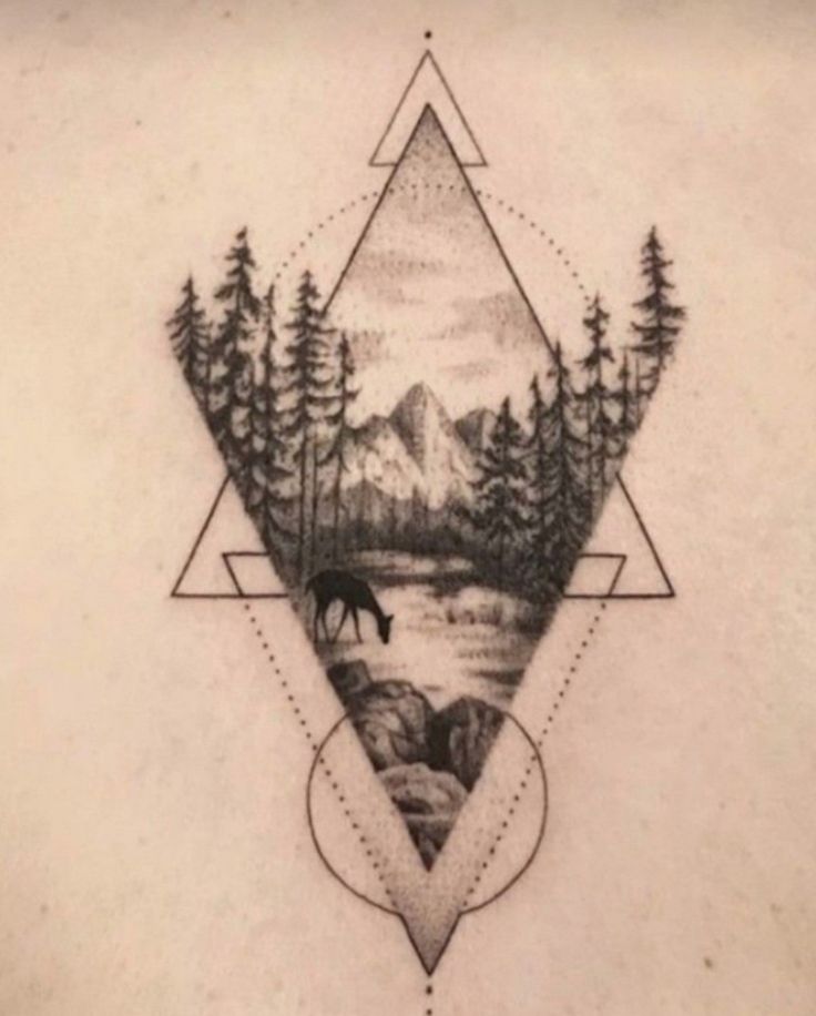 a tattoo with trees and mountains on it