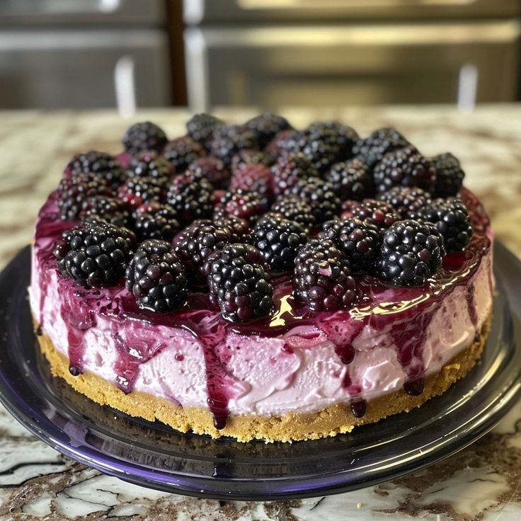 there is a cake with berries on it sitting on the counter top, ready to be eaten