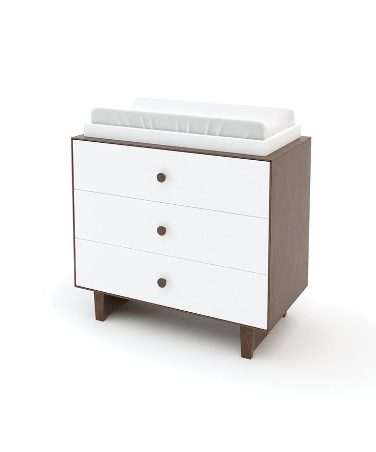 a white dresser with two drawers and a baby crib in the bottom drawer, on an isolated background