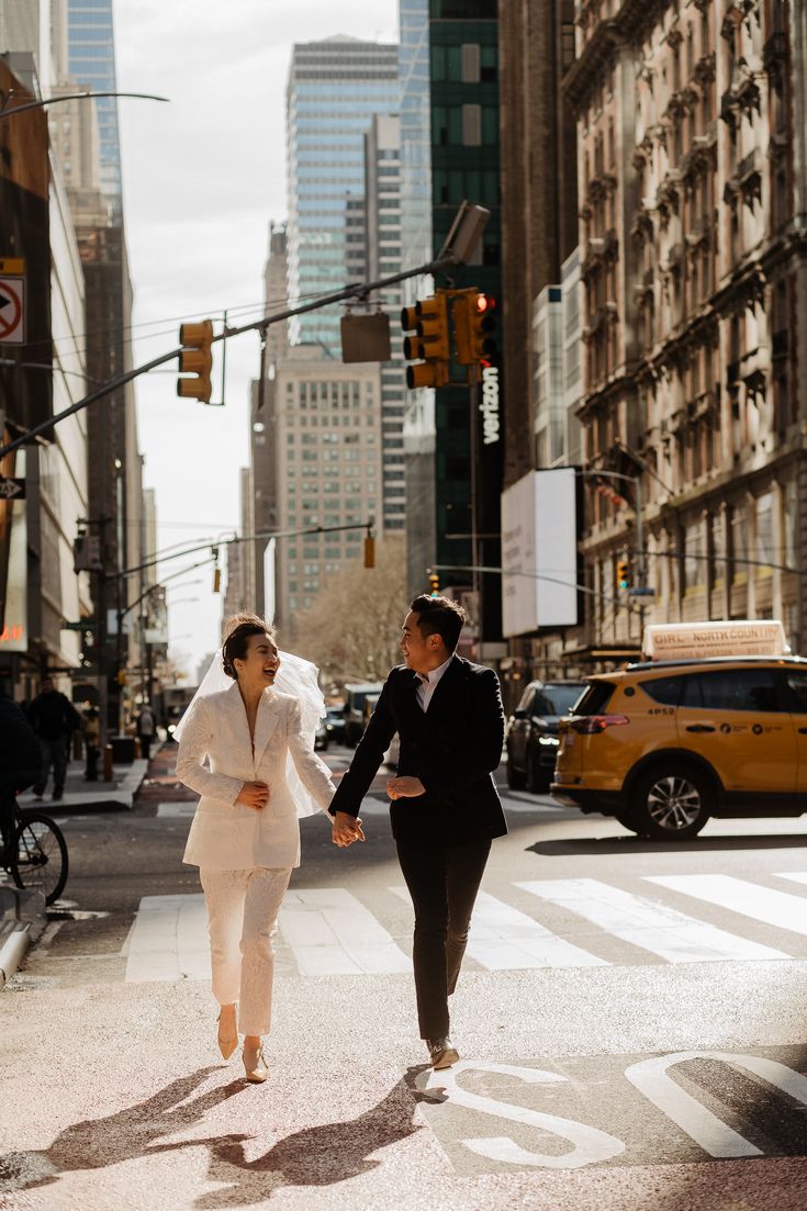 a man and woman are walking across the street