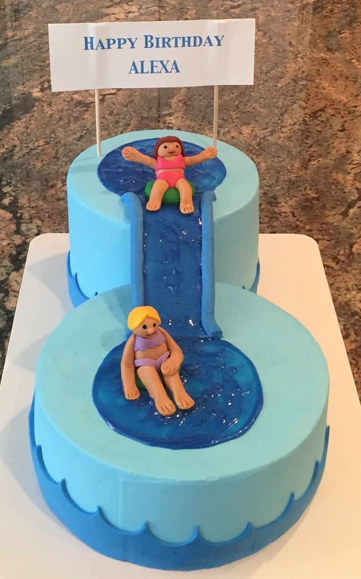 there is a birthday cake with two people in the water on it and a sign that says happy birthday alexa