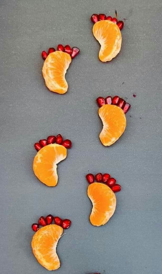 orange slices with red bows on them are arranged in the shape of feet and toes