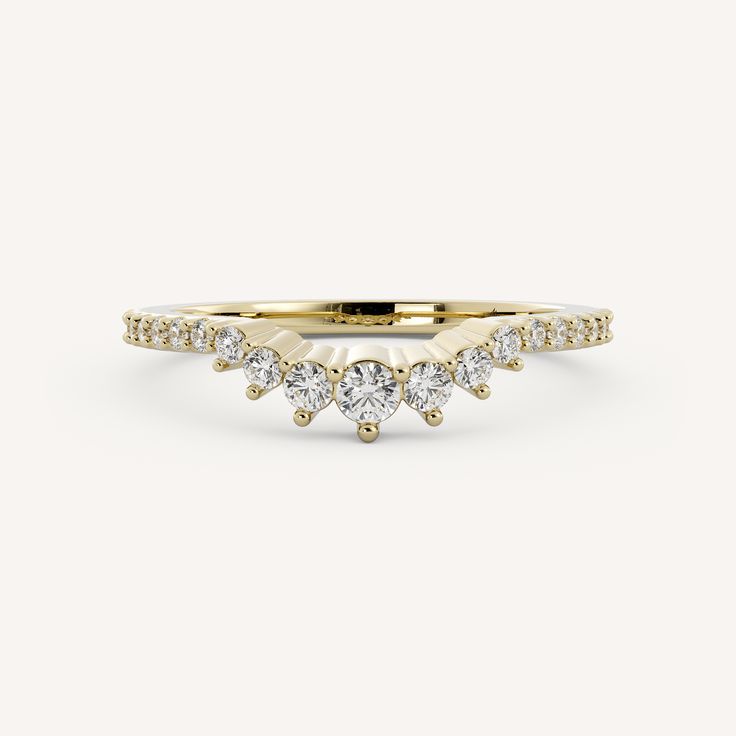 a yellow gold ring with three diamonds on the side and one diamond in the middle