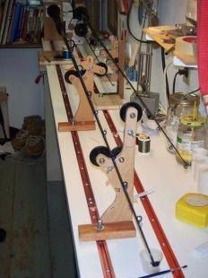 several wooden skis are lined up on a table in a room full of clutter