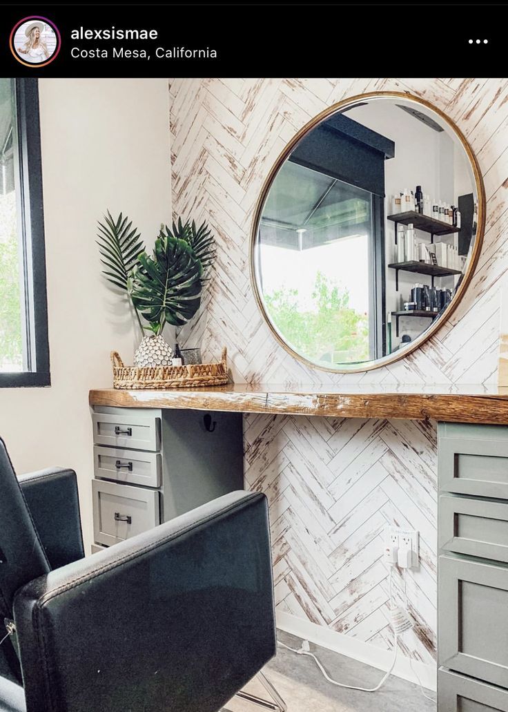 a chair sitting in front of a mirror on top of a wall next to a desk