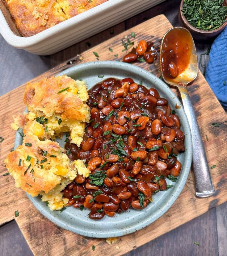 a plate with baked beans and bread on it