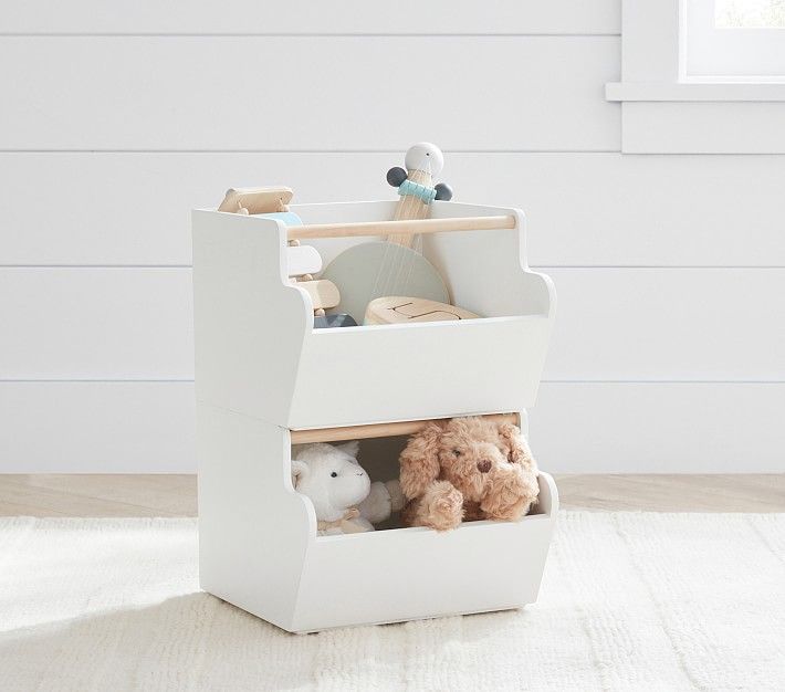 a white toy organizer with stuffed animals in it and the words west elm above it