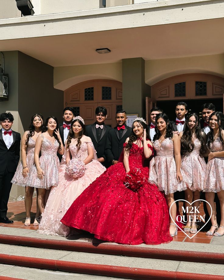 a group of young people in formal wear posing for a photo on the steps of a building