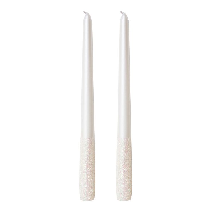 two white candles sitting next to each other