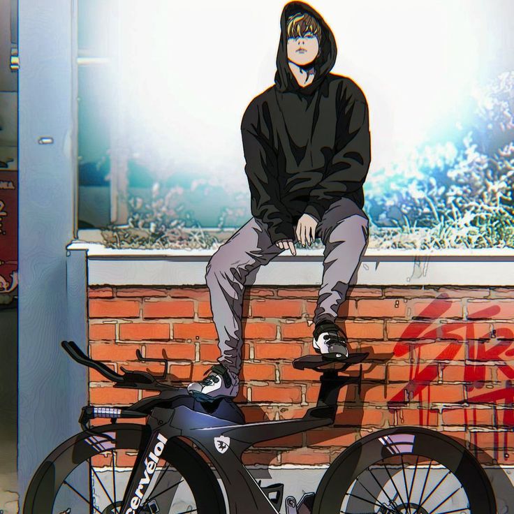 a man sitting on top of a bike next to a brick wall