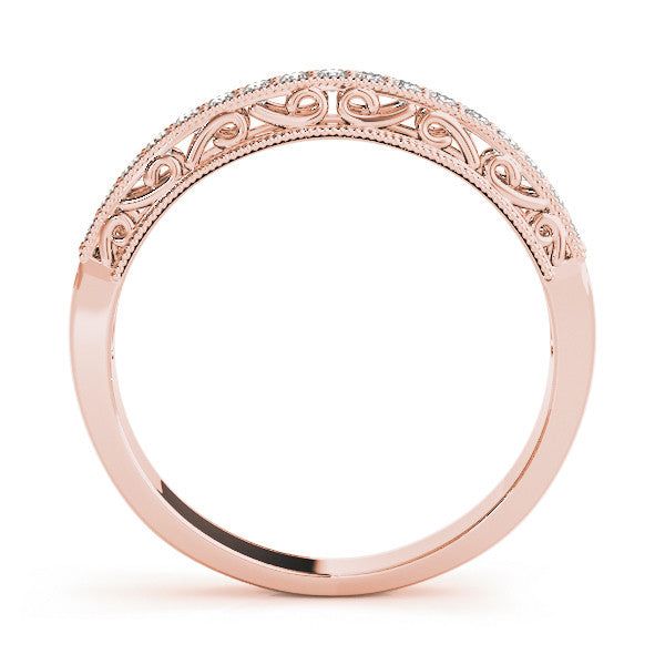 a rose gold wedding ring with an intricate design on the band and side stones in the center